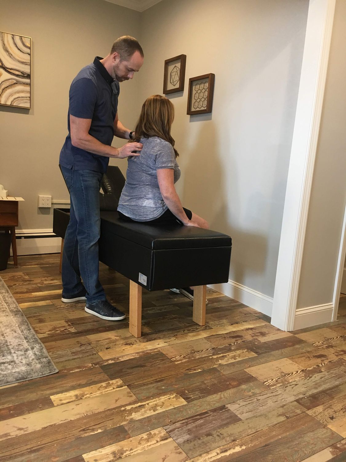Dr. Tom McGuire assessing a patient with sciatica